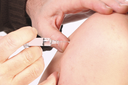 Doctor giving a woman a vaccination