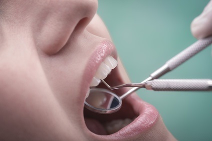 Young woman with perfect teeth and dental instruments