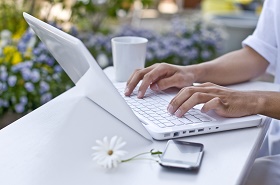 woman-using-white-laptop-lavender-background-sm