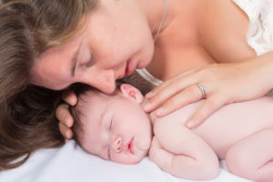 Tender moment between a mother and her 11 days old newborn baby